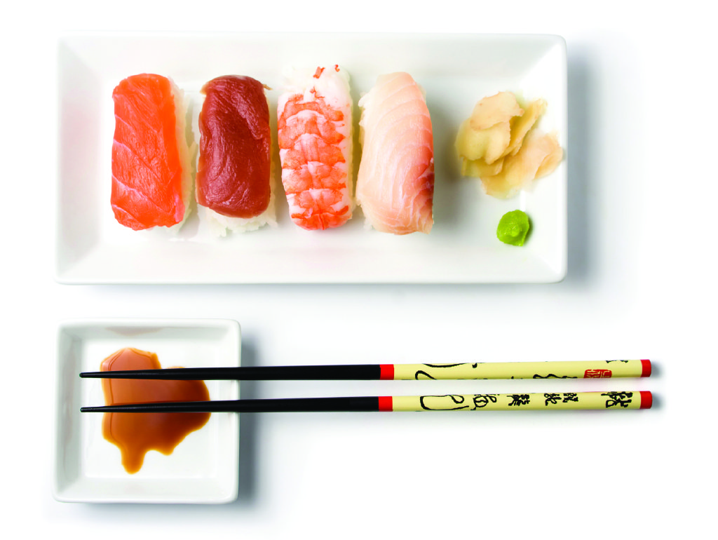 nigiri sushi variation with ginger, soy sauce, wasabi, chop sticks, top view