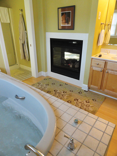 Zen Cottage double-sided fireplace and oversized spa bath